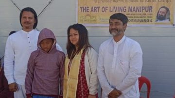 Children at Temporary Shelter received warm clothes from Art of Living